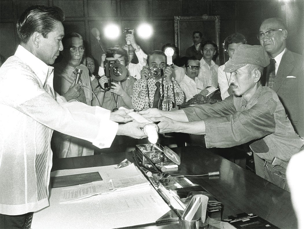 Poslední bojující voják císařské armády kapituluje, vlevo prezident Filipín.